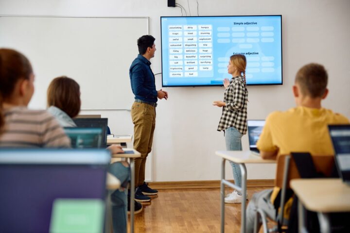 Leraar en leerling voor een les op een digibord